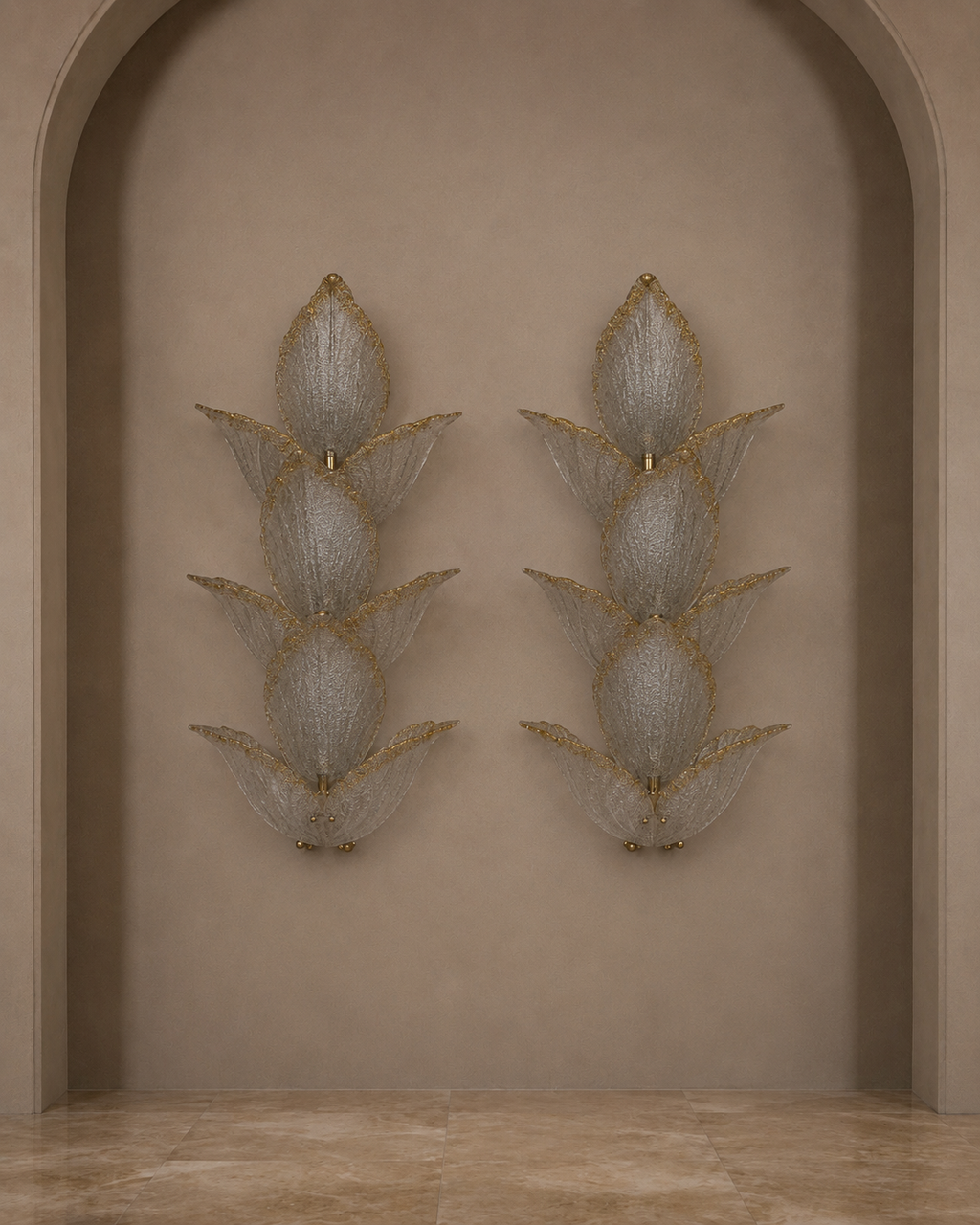 A pair of ornate wall sconces with layered translucent textured shades and gold-toned detailing, mounted symmetrically on a beige plaster archway.