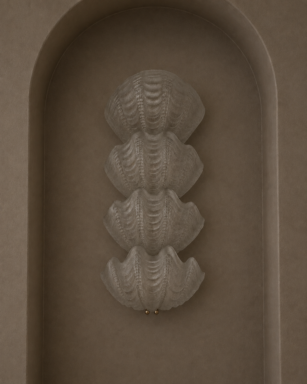 A sculptural wall sconce featuring four stacked, textured clam-shell forms in a warm taupe finish, mounted on a matching arched plaster wall.