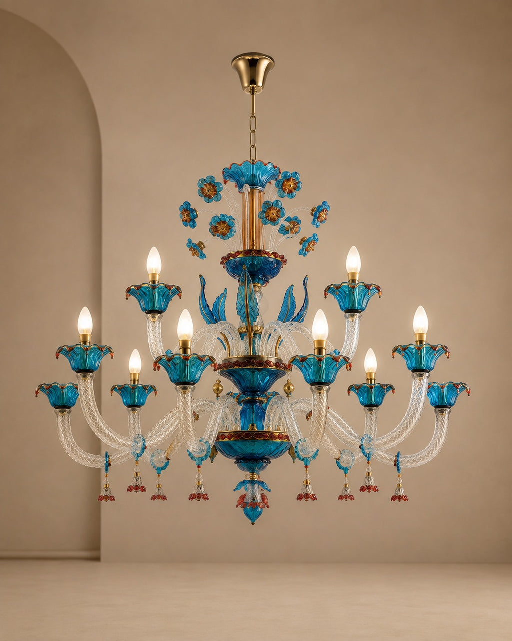 An ornate multi-tier chandelier with vibrant blue glass cups, gold-toned metal arms, and clear crystal strands, shown hanging against a warm beige wall.