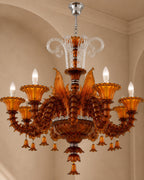 An ornate amber glass chandelier with multiple candle-style lights, hanging from a ceiling in a warm beige interior.