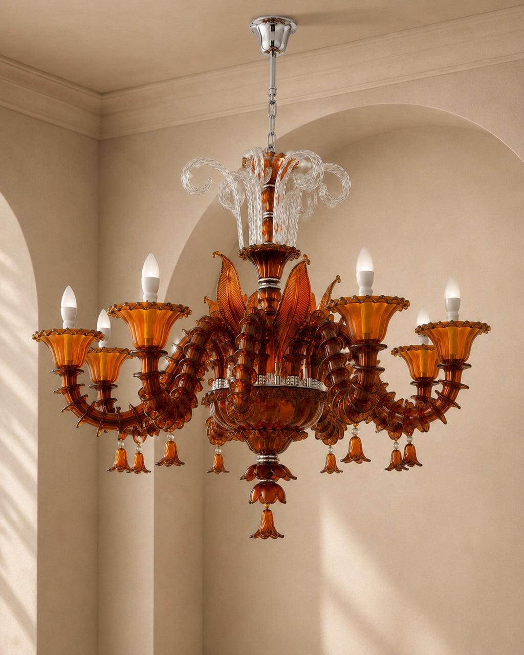 An ornate multi-arm chandelier with amber glass candle-style shades and clear crystal accents, hanging in a beige arched interior room.